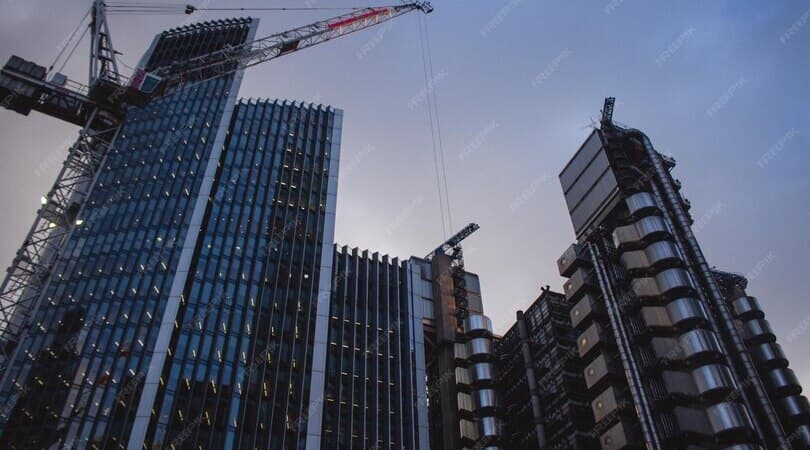 Modern glass high-rise buildings under construction at dusk