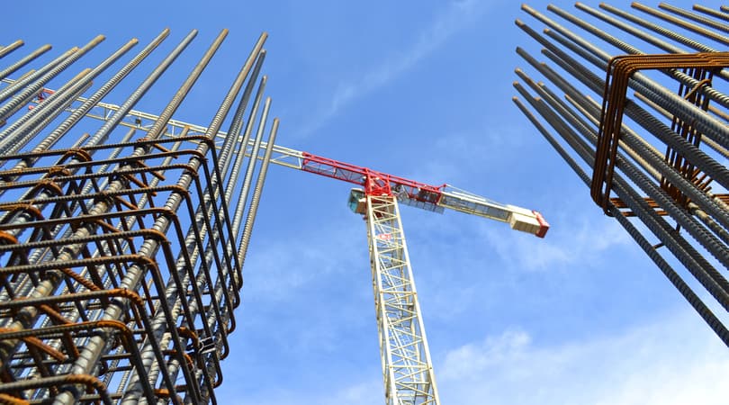 Steel rebar framework and a tower crane at a construction site